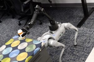 A robot "dog" places a prescription bottle on a table.